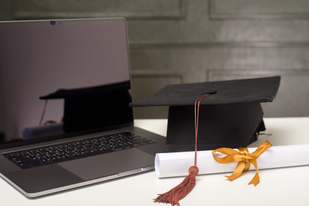 Graduation cap with laptop computer , Online education concept